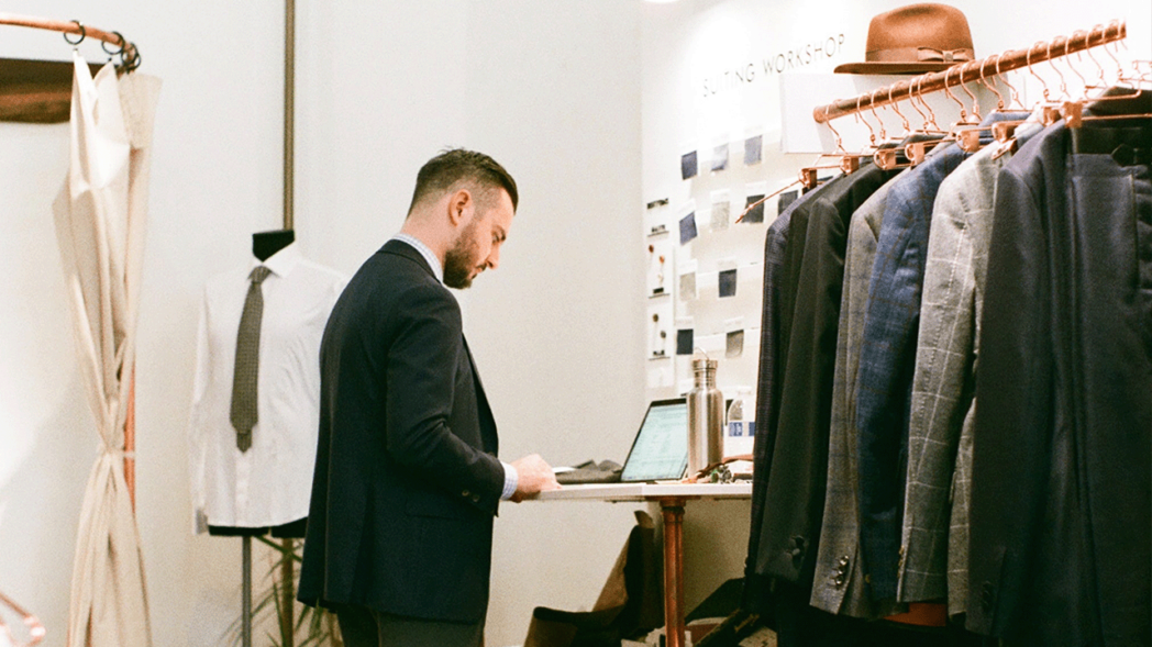 Photo of man working on computer researching tips for wholesale business.