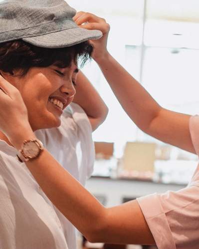 Photo of two happy people where one is helping the other to get dressed, illustrating the idea of ​​how to attract retailers