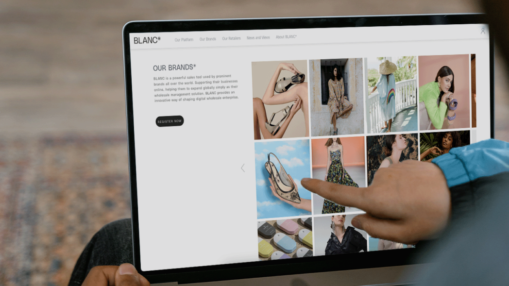 Photo of a person browsing the BLANC platform to find clothing brands for their store