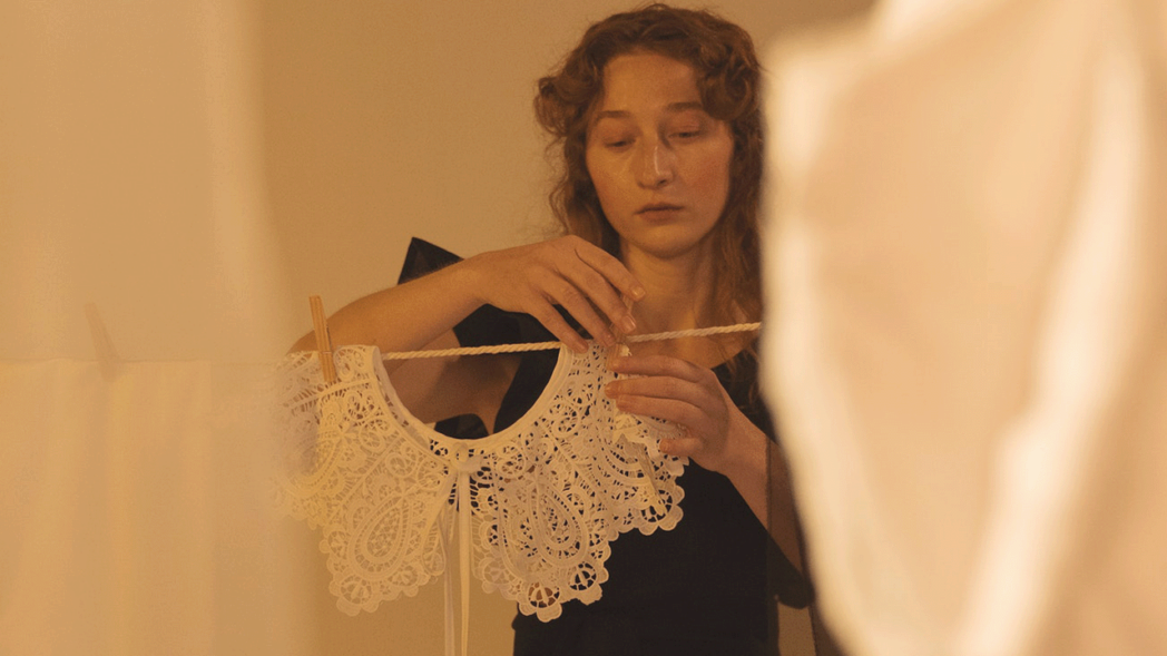 Photo of a woman weaving a garment