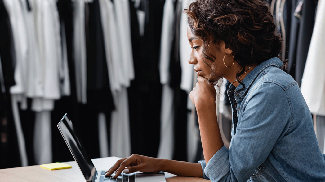 Photo of a woman using her computer to choose a digital platform for b2b wholesale sales