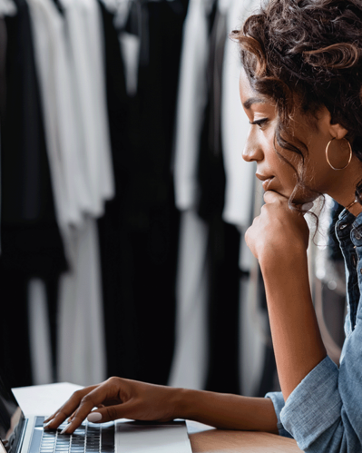 Photo of a woman using her computer to choose a digital platform for b2b wholesale sales